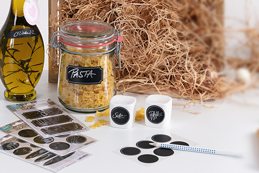 Kitchen countertop with spice labels and bottles with table labels.