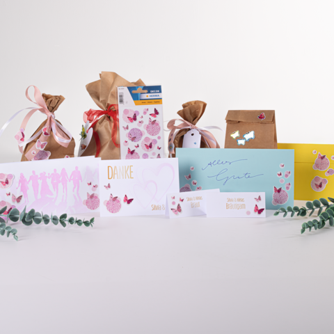 Gift bags and cards in various colors and designs, including a 'Thank You' card and a 'Best Wishes' card, decorated with butterflies.