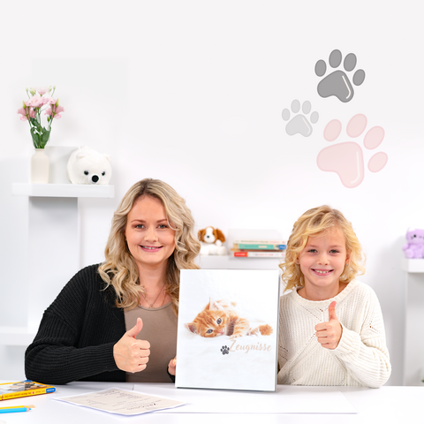A woman and a child are giving a thumbs up while holding a cat book. In the background, paw prints and decorations are visible.