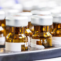 Labels in round adhesive format on brown medicine bottles.