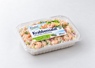 Crab salad with shrimp and dressing in a transparent packaging, labeled 'Fresh and Delicious' and weighing 200 g.