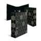 Drei schwarze Ordner mit einem hexagonalen Muster in Gold, aufgestellt in einer offenen Position.