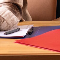 Blue and red binder on the desk.