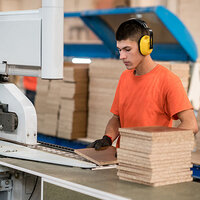 Employee at a saw in furniture production