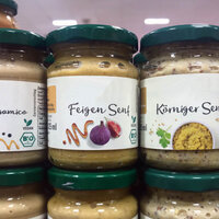 Order roll labels in digital printing online: glass labels on mustard, on the shelf, detail.