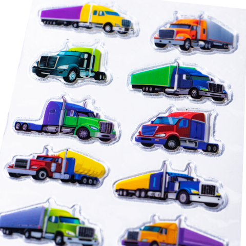 Colorful stickers from trucks in various colors and designs, arranged in two rows.