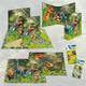 Dinosaur-themed binders and folders featuring colorful illustrations of various dinosaurs in a jungle setting. Also includes stickers.