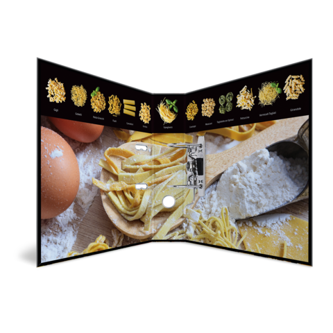 Ein aufgeschlagenes Kochbuch zeigt verschiedene Pasta-Sorten, Eier und Mehl auf einem Holzbrett.