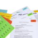 Several documents with colored sticky notes, including a production contract and notes on PBS and Facebook.