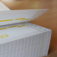 Blank labels: Stack of HERMA foldable labels, also known as computer labels or perforated edge labels.