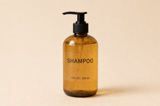 Brown shampoo bottle with a pump dispenser, labeled 'SHAMPOO' and indicating a size of 8 FL OZ / 236 mL.