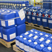 GHS labels and chemical labels on blue plastic canisters, on pallets.