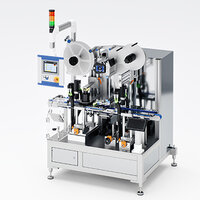 Automated labeling machine with multiple rolls, control unit, and various conveyor mechanisms for packaging.