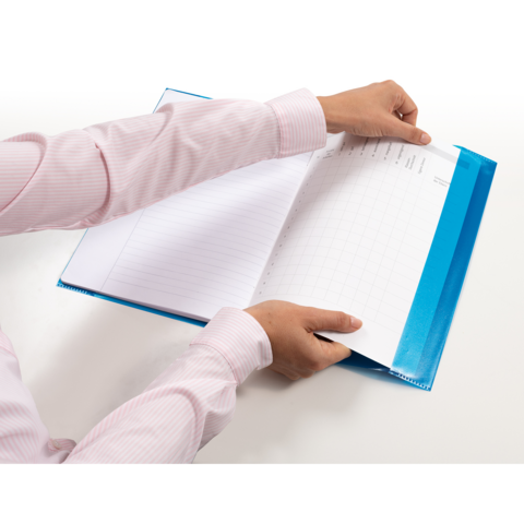 A person is flipping through an open binder filled with lined and graph paper. Their hands are dressed in a long-sleeved shirt.