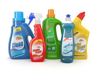 Six bottles of cleaning products in various colors and shapes, including window cleaner, all-purpose cleaner, and toilet cleaner.