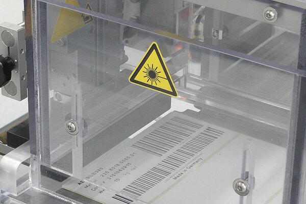 Laser-activatable labels: with barcode in the production process, close-up of the CO2 laser printing unit.