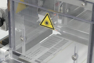 Laser-activatable labels: with barcode in the production process, close-up of the CO2 laser printing unit.