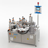 A labeling machine with multiple stations, equipped with cylinders and a control panel for operation.