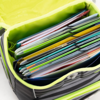 School backpack with collection folders photographed from above.